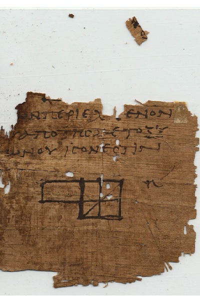An ancient, frayed fragment of brown papyrus features faint handwritten Greek text and a simple geometric ink sketch.Discovered at Oxyrhynchus, Egypt, this artifact contains a diagram and passage from Book II, Proposition 5 of Euclid's Elements. The hand-drawn figure shows a partitioned rectangle divided into squares with a diagonal line slicing through the rightmost sections, serving as an early visual proof for an algebraic identity. The papyrus edges are jagged and heavily weathered, with a tiny separated scrap hovering just above the main fragment against a plain white background.
